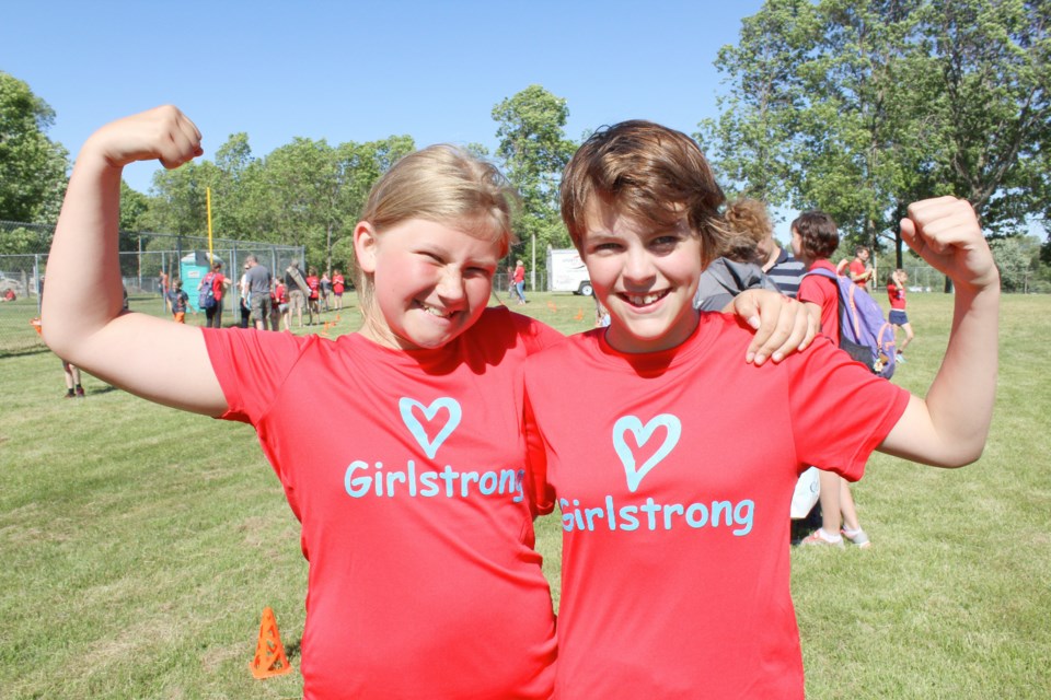 Girl power: Hannah MacKenzie, left, and Molly Absalom show off their pipes after finishing the Girlstrong run Thursday at Tudhope Park. Nathan Taylor/OrilliaMatters