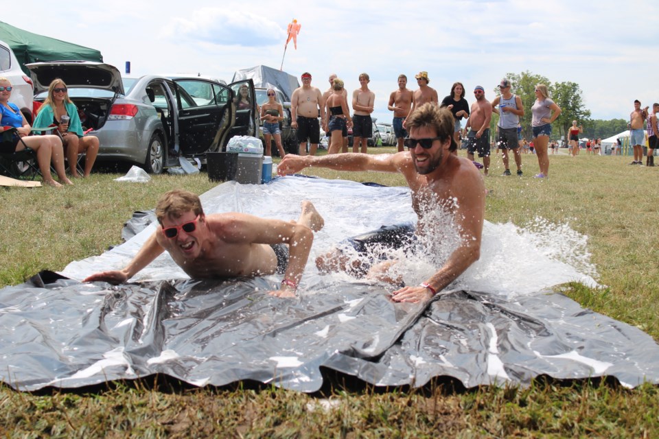 Caelan Flanagan, left, and his brother, Brendon Flanagan, brought their slip-and-slide with them from Toronto. It was a crowd pleaser in the VIP camping area. Nathan Taylor/OrilliaMatters