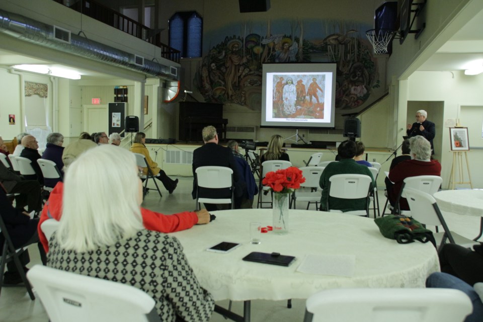 Visitors to St. James' Anglican Church watch the slideshow Saturday showing paintings that were part of artist Brian Lorimer’s Project Remembrance. Mehreen Shahid/OrilliaMatters
