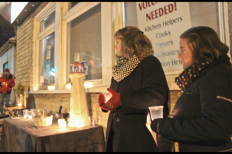Lynn Thomas, left, development co-ordinator with the Lighthouse Soup Kitchen and Shelter, and operations manager Trish Holloway take part in a candlelight vigil Wednesday. Nathan Taylor/OrilliaMatters