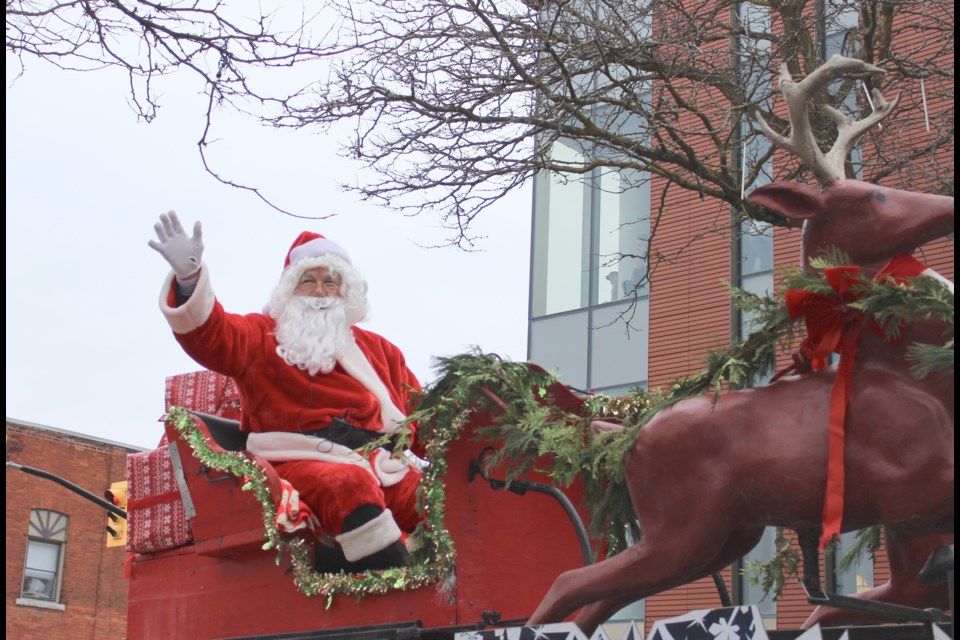 The main attraction: Santa waves to the crowd during the Orillia Santa Claus parade Sunday. Nathan Taylor/OrilliaMatters