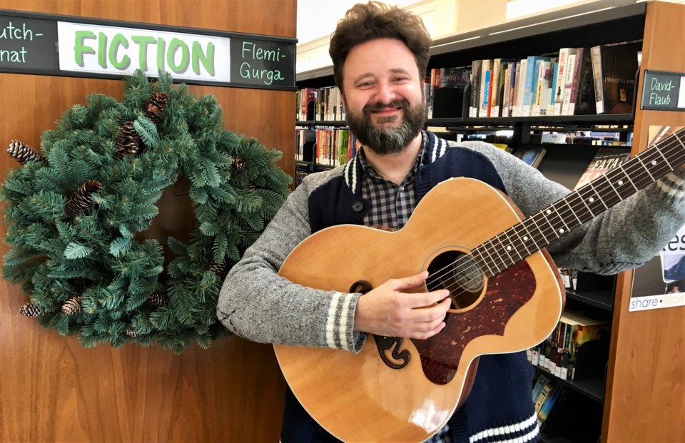 2018-12-04 Darrin playing guitar in library