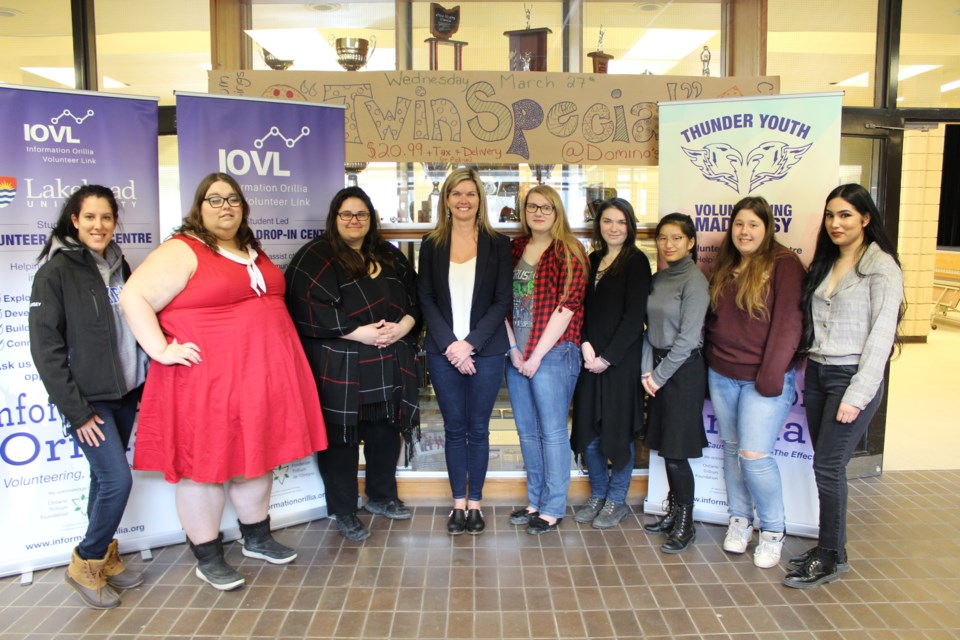 Simcoe North MPP Jill Dunlop, fourth from left, and Sukhi Kaur, far right, of Information Orillia, are shown Friday at Twin Lakes Secondary School with some of the students who will be running pop-up volunteer and information centres at local schools. Nathan Taylor/OrilliaMatters