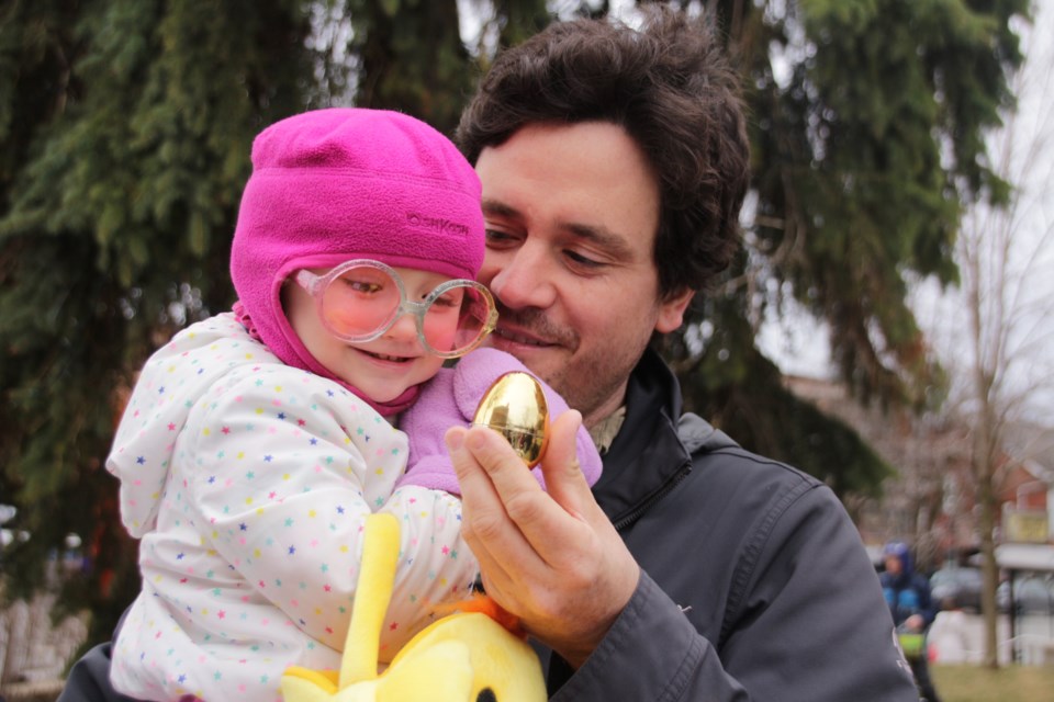 Luna Porter, 2, of Orillia, found the golden egg at Saturday's Downtown Orillia Easter Egg Hunt, which won her a free cupcake from Mariposa Market. She is pictured with her father, Jesse Porter. Mehreen Shahid/OrilliaMatters