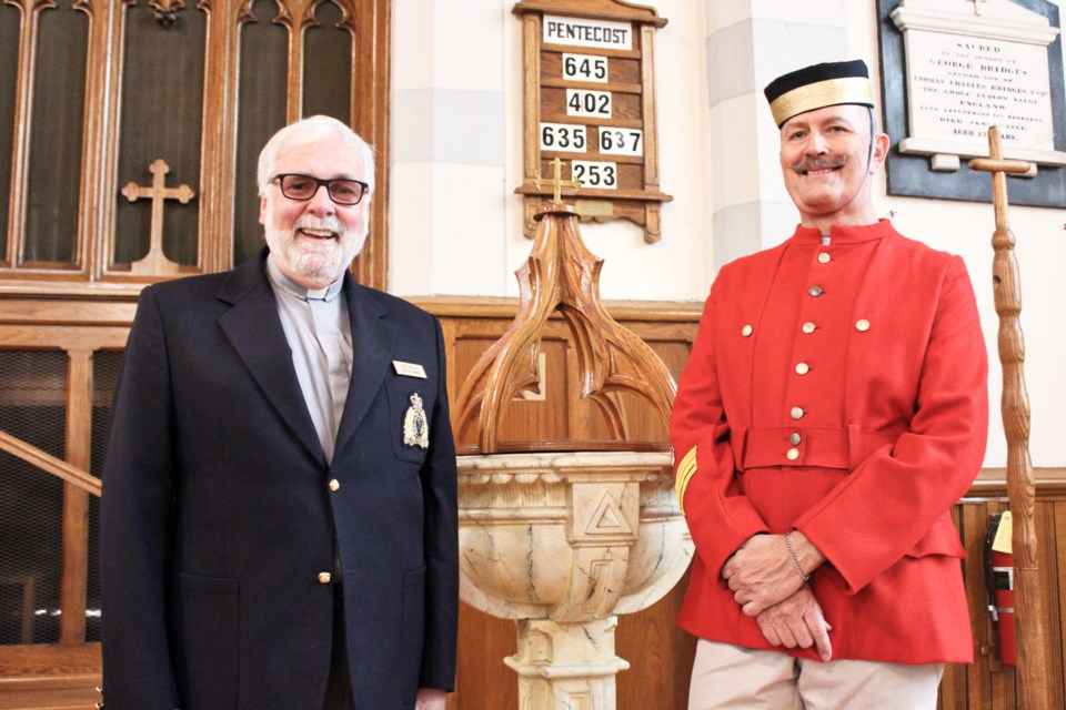 RCMP chaplain Gerry McMillan, left, and Michael Beresford, donning a replica of a uniform worn by Sir Sam Steele, are shown Friday at St. James' Anglican Church in Orillia, next to the font that was used to baptize the famous police officer more than 100 years ago. Nathan Taylor/OrilliaMatters
