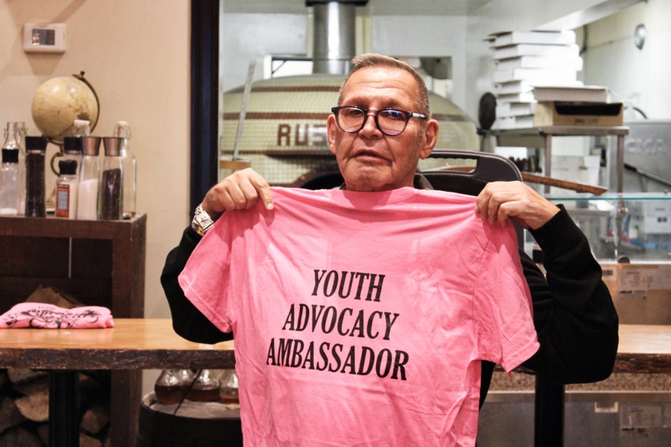 Chuck Panozzo, co-founder of Styx, shows off the shirt he was given Friday during the Chuck Panozzo Youth Legacy Award ceremony at Rustica Pizza Vino. Nathan Taylor/OrilliaMatters