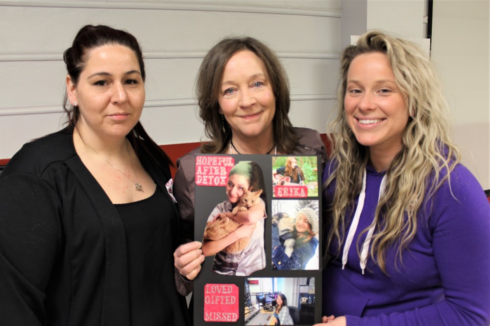 Kathy Cole, centre, holds photos of her daughter, Erika, who died of an accidental overdose. Also pictured are Erika's friends, Tarah Harper, left, and Jess Turton, who, for the first time, publicly shared the story of her own struggles with addiction. The three attended the Orillia Talks event Wednesday at the Geneva Event Centre. Nathan Taylor/OrilliaMatters