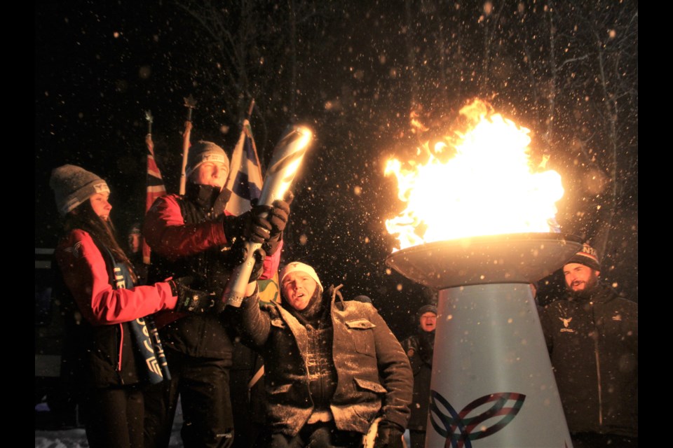 The torchbearers weren't expecting the cauldron to go up in flames as fast as it did during the opening ceremonies for the Orillia 2020 Ontario Winter Games on Thursday at Couchiching Beach Park. From left are figure skaters Sophia Gover and Daniel Patriquin and Paralympian Bradley Bowden. Nathan Taylor/OrilliaMatters