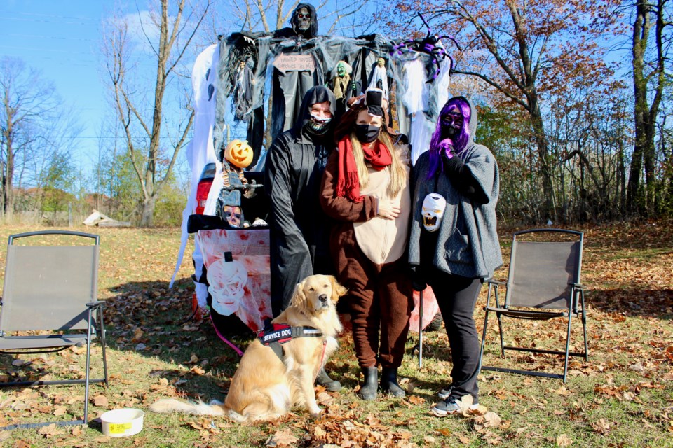 Among those handing out goodies at last year's Trunk or Treat event were Alan Wilson, Dale Ranson, centre, and Sara Ranson. They are shown with their dog, Shelby. Nathan Taylor/OrilliaMatters