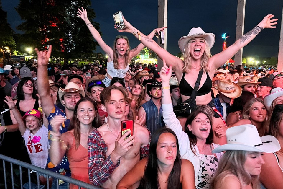 Fans go wild during the kickoff of the Boots and Hearts Music Festival on Thursday night at Burl's Creek Event Grounds in Oro-Medonte. 