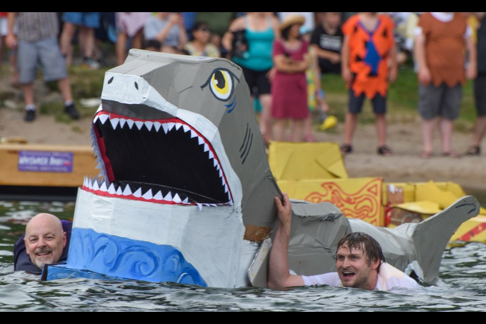 City councillor David Campbell, left, and his council counterpart, Jay Fallis, swim with the shark to attack other boats in Sunday's cardboard boat race at Couchiching Beach Park. The beach area was packed with spectators for the race, which is the marquee event for the Orillia Waterfront Festival, organized by the Orillia District Chamber of Commerce.