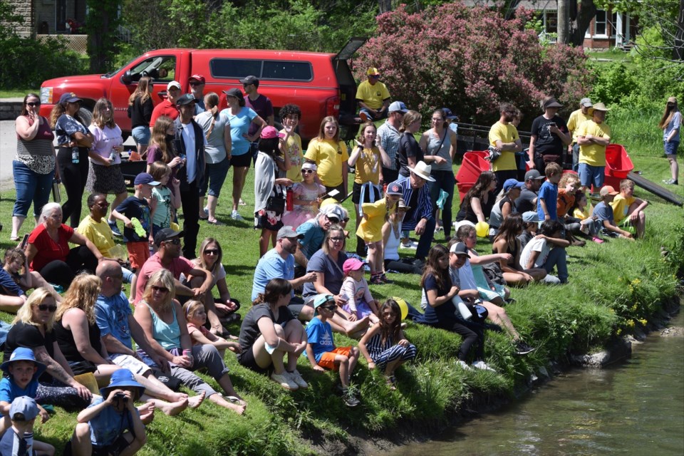 Spectators line the bank of the Coldwater River for the start of the Coldwater Lions Club Duck Race Saturday.