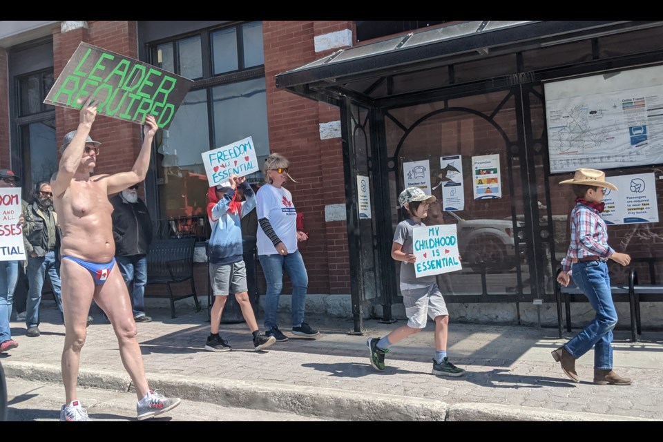 A group of 60-70 people, many carrying hand-made placards and chanting for freedom and better leadership, marched down West Street Friday morning as part of a so-called 'freedom rally.'