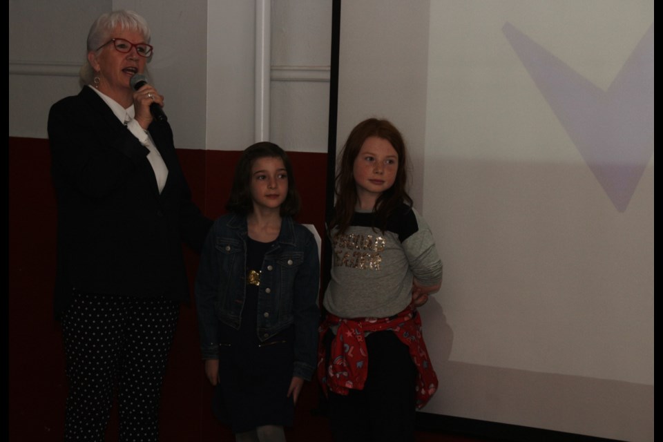 Mary O’Farrell-Bowers helps nine-year-olds Alida Tomasini and Ava Shami take questions from the judges. The two won $150 from the judges. Mehreen Shahid/OrilliaMatters