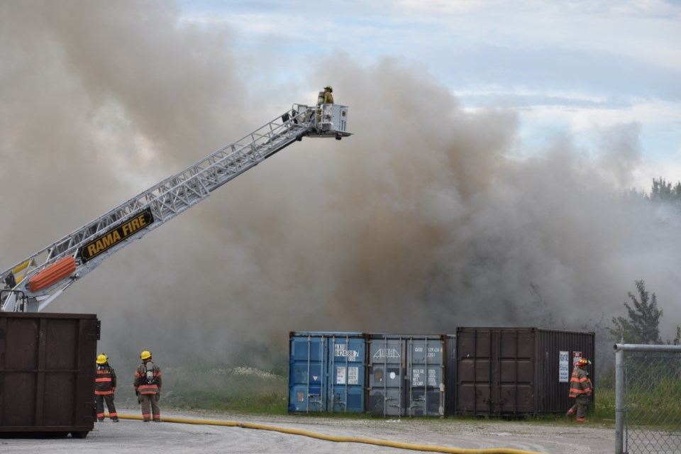 The Rama Fire Department's aerial truck was deployed to help fight the garbage fire from above Friday evening. Dave Dawson/OrilliaMatters 