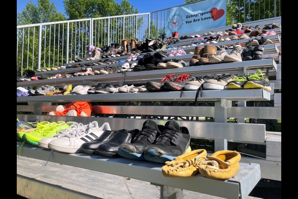 Over 100 pairs of shoes fill the bleachers at John Snake Memorial Multipurpose Grounds in Rama to honour the 215 Indigenous children in Kamloops, B.C., whose bodies were found buried on the grounds of one of Canada’s largest residential schools. 