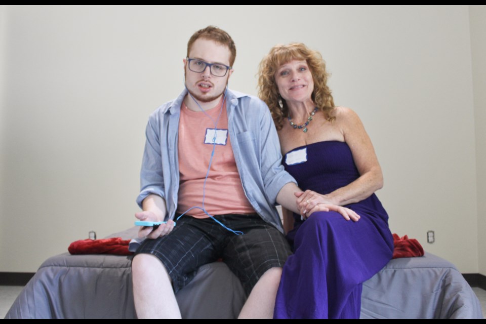 Scott MacNeill and his mother, Karen McCoy, are shown Friday in MacNeill's room at Apple Blossom Village, a home in Oro-Medonte for adults with complex care needs. Nathan Taylor/OrilliaMatters