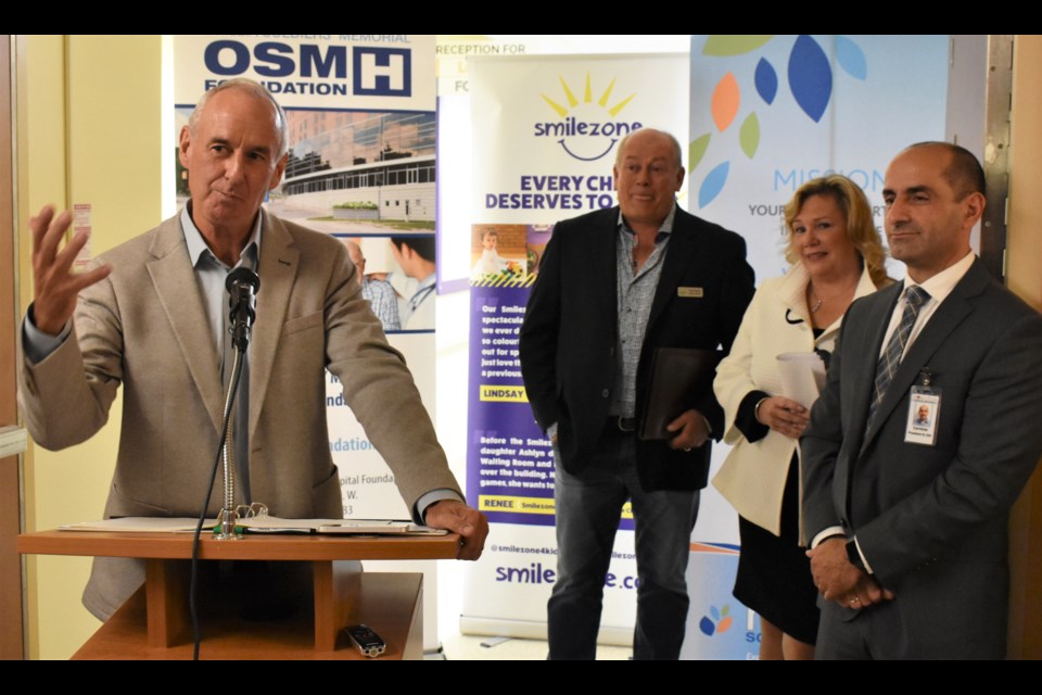 Hockey Night in Canada host Ron MacLean speaks at Thursday’s unveiling of the new outpatient pediatric unit at Orillia Soldiers’ Memorial Hospital. In the background, from left, are Scott Bachly (Smilezone Foundation co-founder), Cheryl Harrison (vice-president of regional patient programs) and Carmine Stumpo, the hospital’s new president and CEO. Dave Dawson/OrilliaMatters