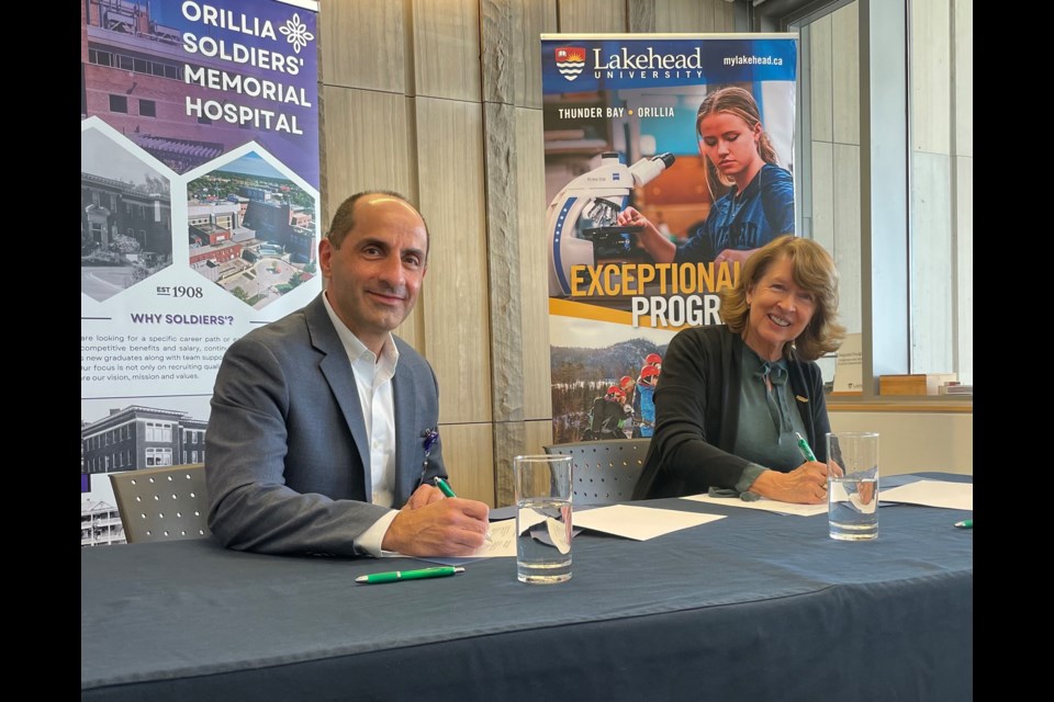 Orillia Soldiers' Memorial Hospital president and CEO, Carmine Stumpo, and Lakehead University president and vice-chancellor, Moira McPherson, signed a memorandum of understanding on Tuesday afternoon. 