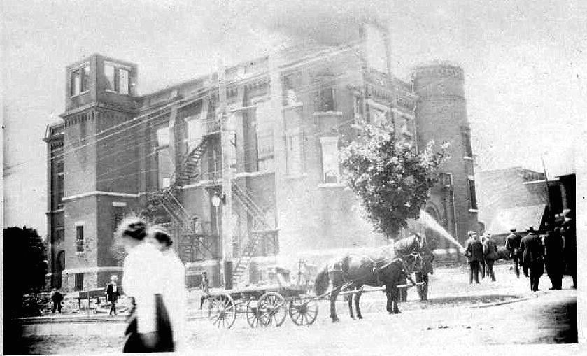 The morning after a fire ravaged the Orillia Opera House in 1915, firefighters pour water on the smouldering ruins.