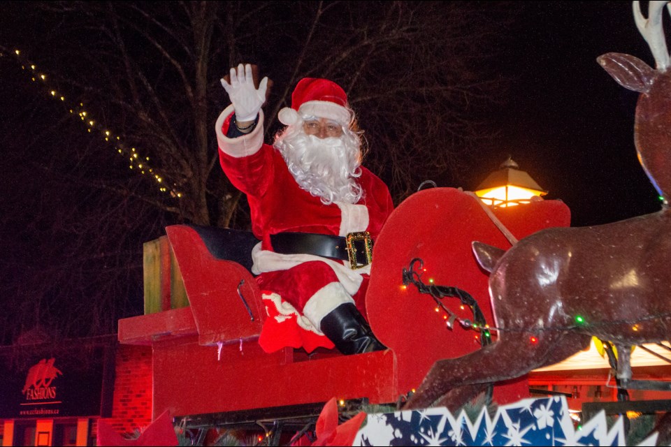 Santa Claus waves to children young and old during the Orillia Santa Claus Parade Saturday night.