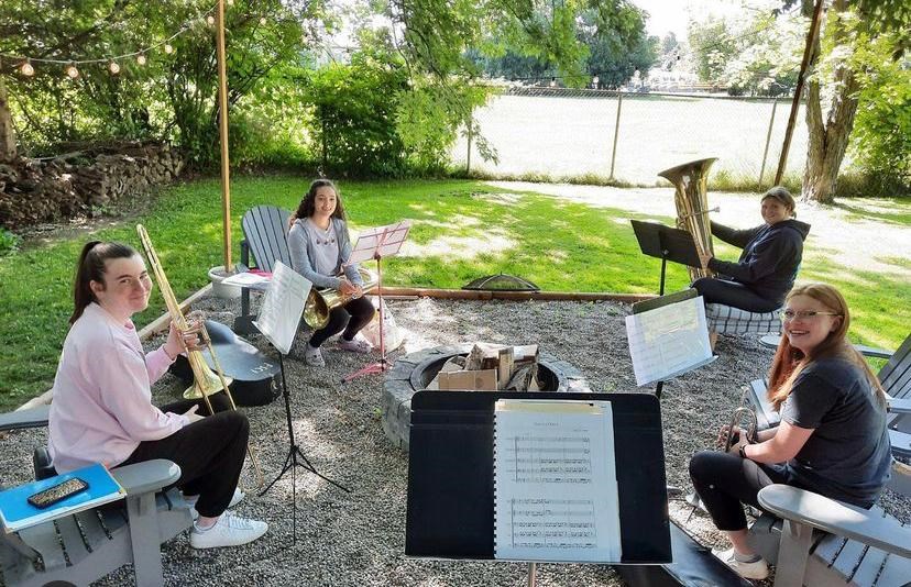 Brazzledazzle, a brass quartet composed of students from Orillia Secondary School, gathered in a member's backyard for outdoor rehearsals before their performance at Theo's Eatery. This fall, the group has been performing at local longterm care residences.