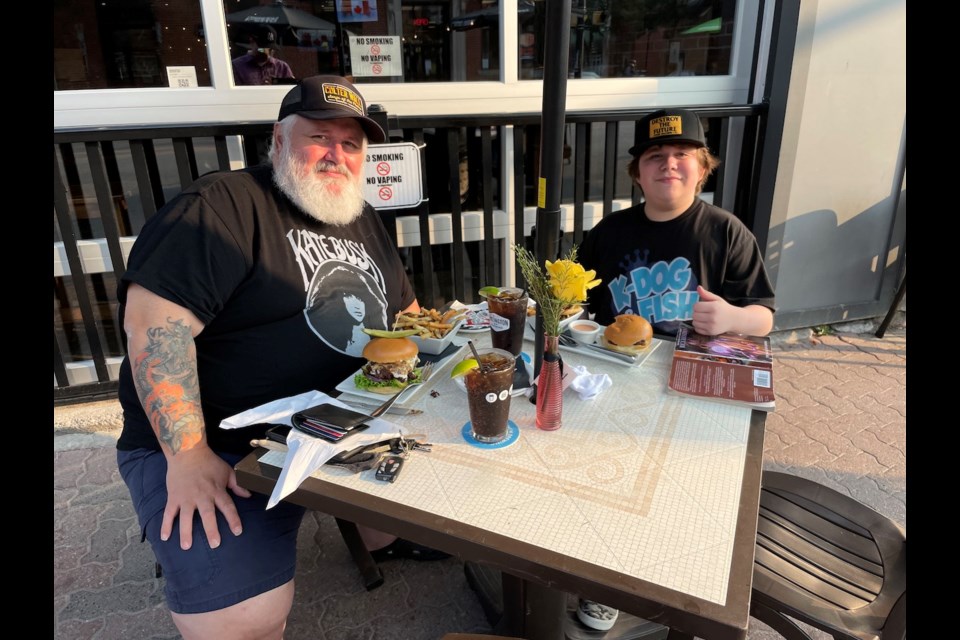 Joe Cornelisse and his son, Ben, enjoyed a burger at Kenzington Burger Bar during this weekend's See You on the Patio festivities. 