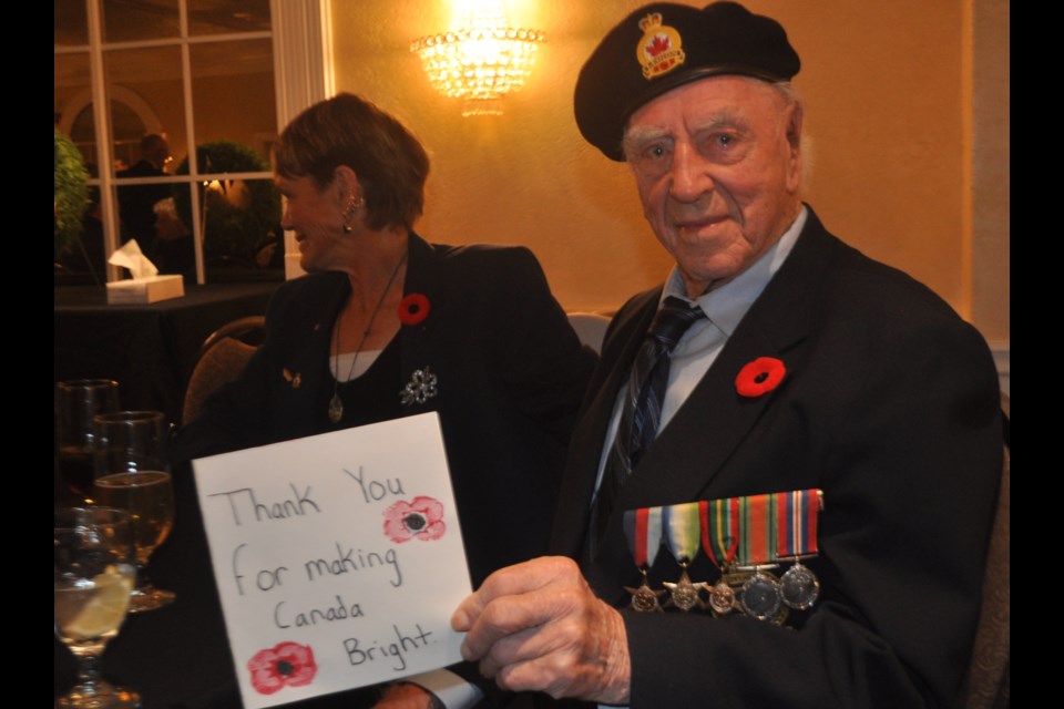 World War II veteran Jim Barnett holds one of the cards created by local elementary school students from Harriett Todd Public School to honour area veterans at the 15th annual Take a Vet to Dinner event Saturday night. Andrew Philips/OrilliaMatters