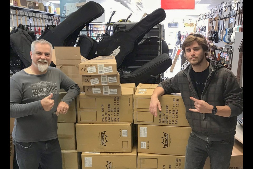 Jeff Gilbert, left, of Gilbert Guitars, and Ethan Mask, of the Orillia Youth Centre, are shown with some of the equipment the youth centre was able to purchase thanks to a MusiCounts grant. Supplied photo