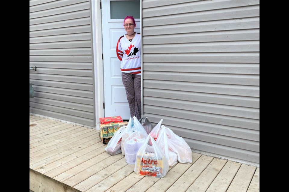 Steve Stoutt, of RE/MAX Orillia, delivered groceries to this grateful resident on Wednesday. His company is offering to pick up and deliver groceries and other necessities to those in need during the COVID-19 pandemic. Supplied photo
