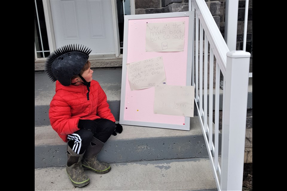 Connor Whittet, 6, tries to solve a math problem Wednesday during a math scavenger hut in West Ridge. Supplied photo