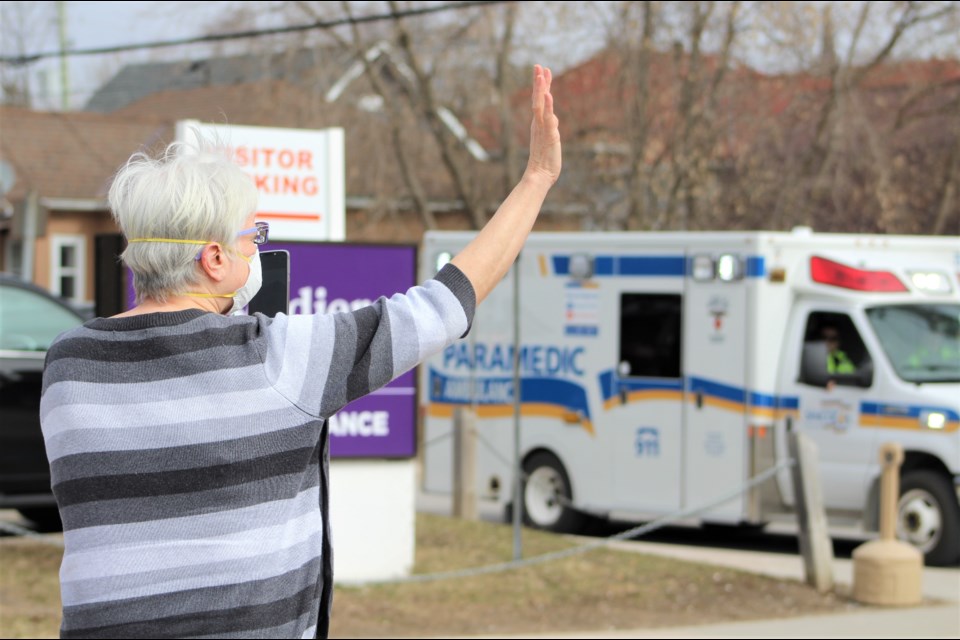 A woman waves at paramedics Friday during a first responders' salute to Orillia Soldiers' Memorial Hospital staff and volunteers. Nathan Taylor/OrilliaMatters