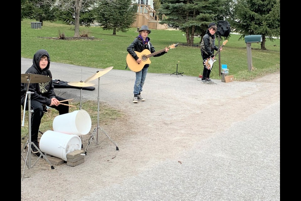 Members of the band Seven Days Past have been performing at the end of a driveway in Ramara while collecting money for The Sharing Place Food Centre. From left are Cole Perreault, 10, Carter Perreault, 11, and Tanner Greenwood, 10. Absent: Oliver Sawatzky. Supplied photo