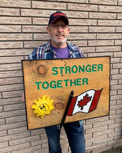Larry Whitehead is shown with one of the signs he has made to lift people's spirits during the COVID-19 pandemic. Supplied photo