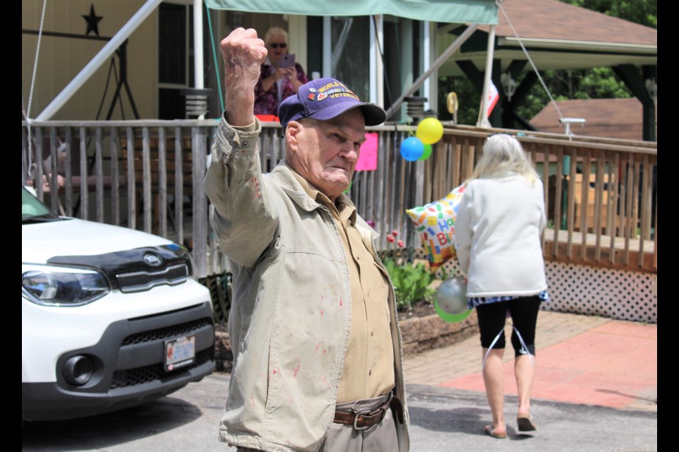 Harold Rowden watches as friends parade past his Ramara home Sunday to wish him a happy 96th birthday. Nathan Taylor/OrilliaMatters