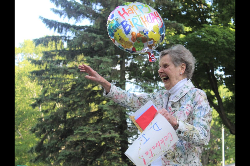 Donnajean Jefferies reacts as friends drive past her house Monday to wish her a happy 90th birthday. Nathan Taylor/OrilliaMatters