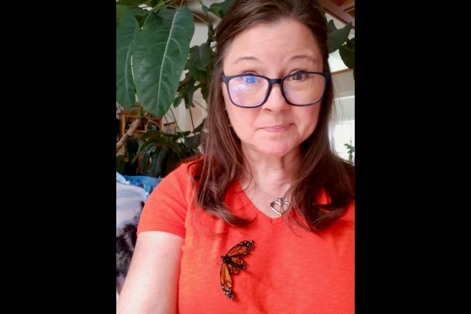 Krista Storey is shown with Braveheart, a monarch butterfly that suffered from a parasite.