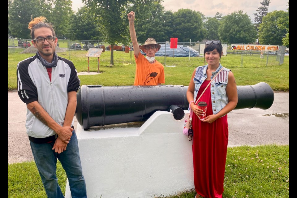 Nathan Patterson, left, Clifford Perry and Krystal Brooks say they're the ones who spray-painted cannons in Couchiching Beach Park just before Canada Day. They are shown with one of the cannons, which has since been repainted.