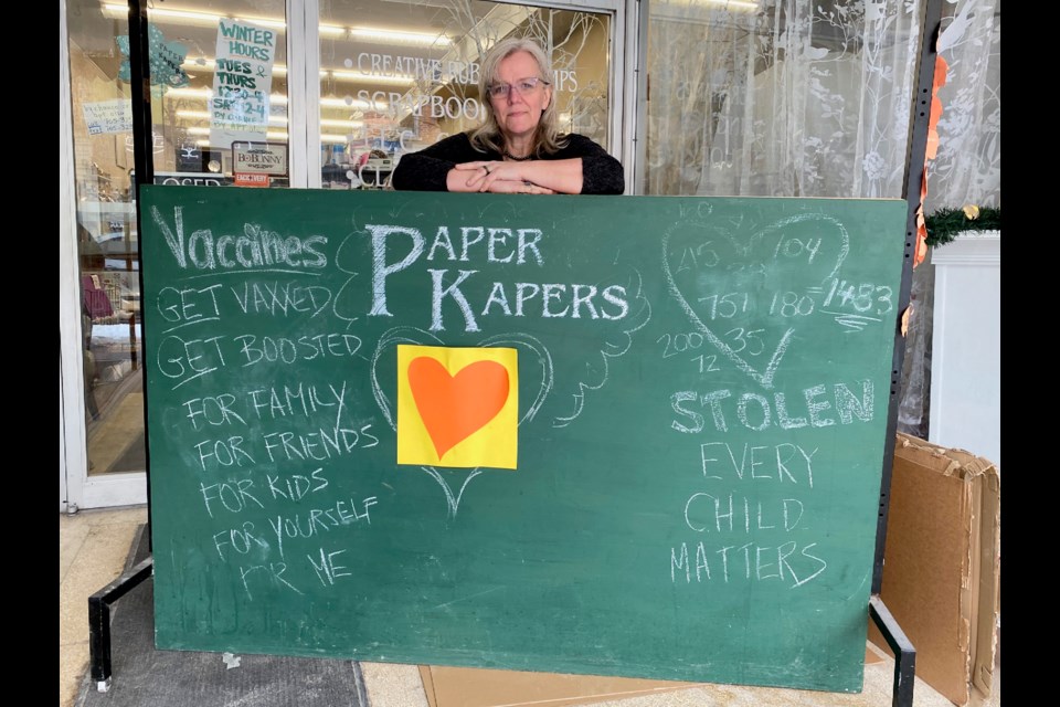 Ellen Wolper is shown at the entrance to her downtown Orillia shop, Paper Kapers.