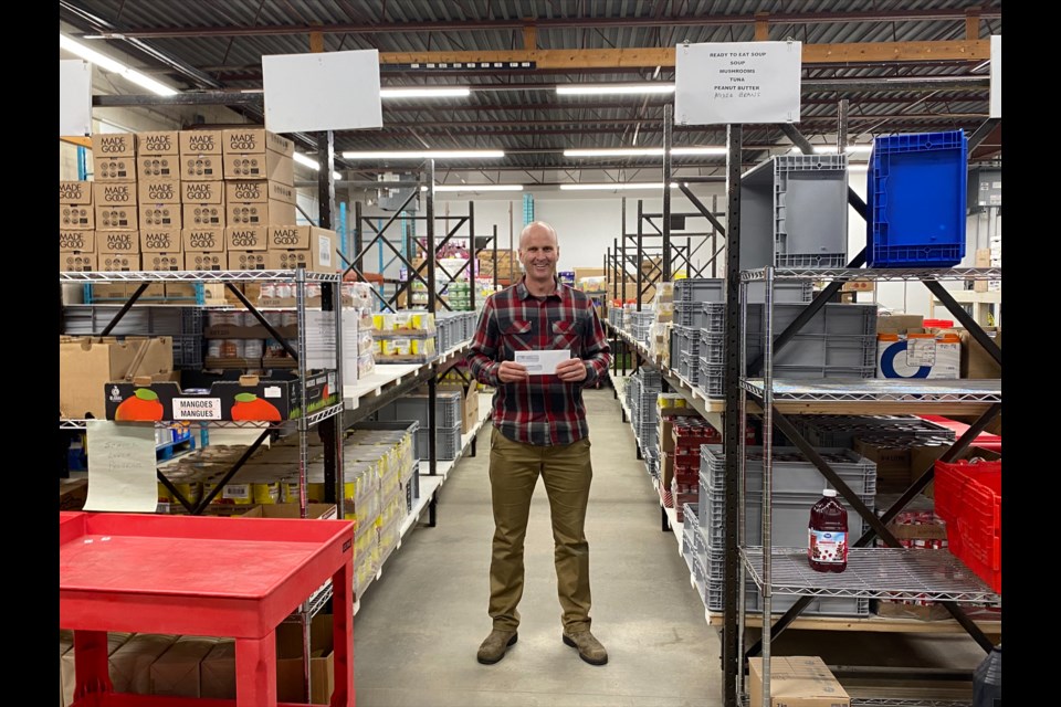 Chris Peacock, executive director of the Sharing Place Food Centre, is shown in the warehouse where School Fuel kits are put together.