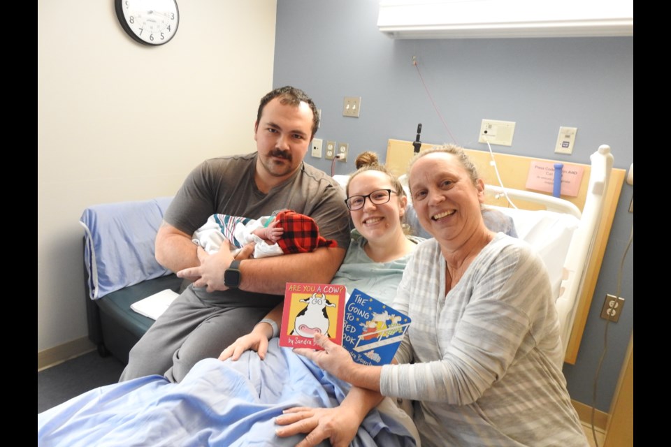 Sarah and Tyler Olmstead are shown with baby Rory and Nana Trudy.