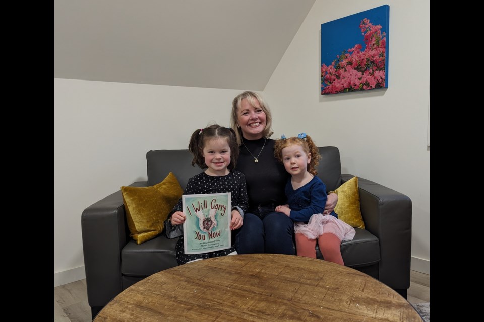 Steph Dunn, shown with daughters Fiona and Eleanor, is the author and illustrator of I Will Carry You Now.
