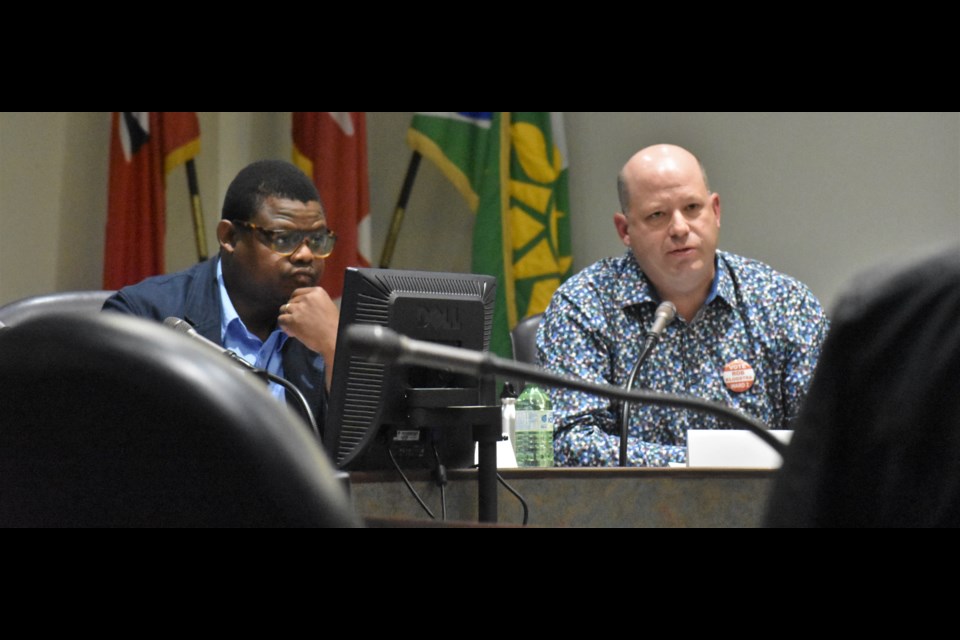 Ward 2 candidate Tshweu Moleme listens as incumbent councillor Rob Kloostra answers a question from the audience during the Ward 2 all-candidates forum Wednesday night at the Orillia City Centre. Dave Dawson/OrilliaMatters