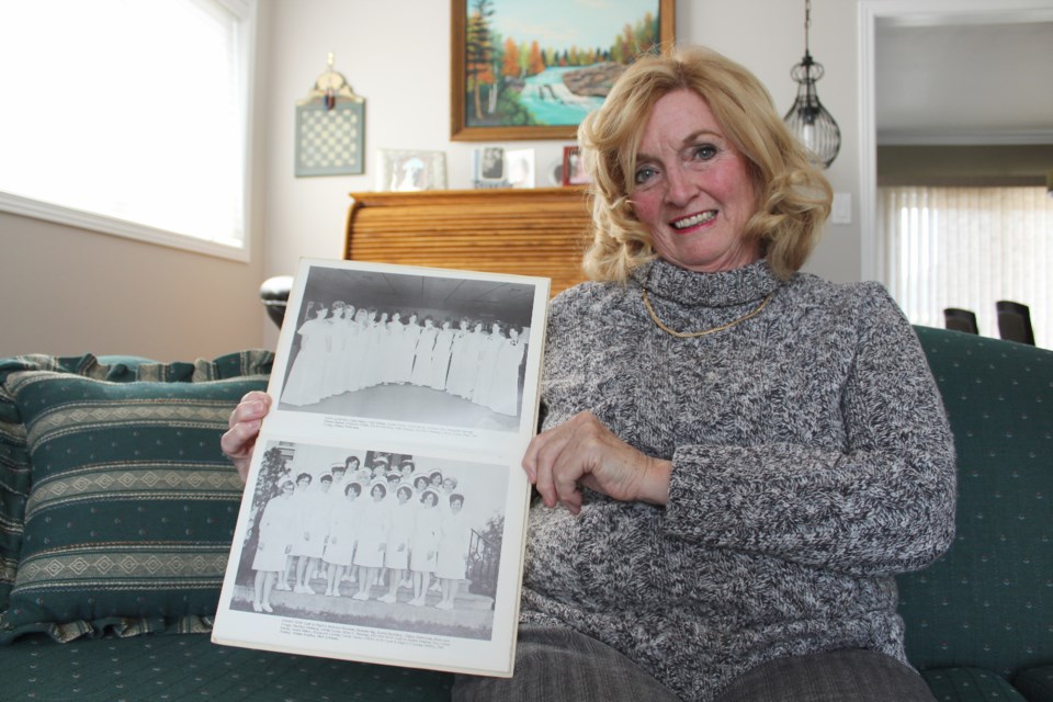 Glenna Tinney, of the Orillia Soldiers' Memorial Hospital Nurses Alumnae, is shown with photos of the nursing class of 1968. Nathan Taylor/OrilliaMatters