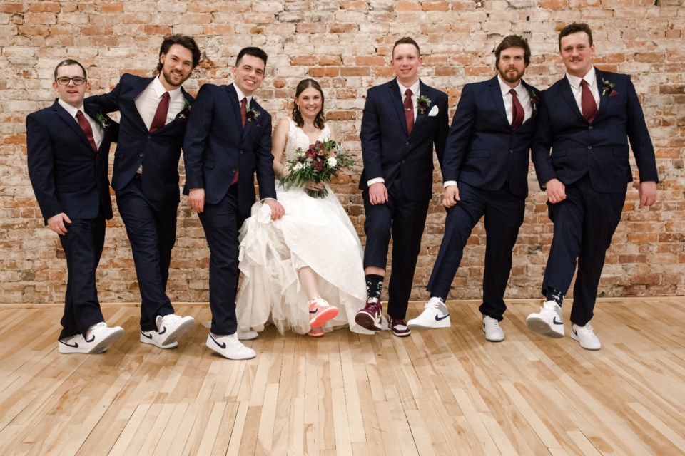 Tamara and Tyler Evans were married in Creative Nomad Studios in December 2022. From left are groomsmen Liam Macdougall, Max Nogy, Mitchell Hurtubise, bride Tamara Evans, groom Tyler Evans, groomsmen Danny Forbes and Josh McCreith. 