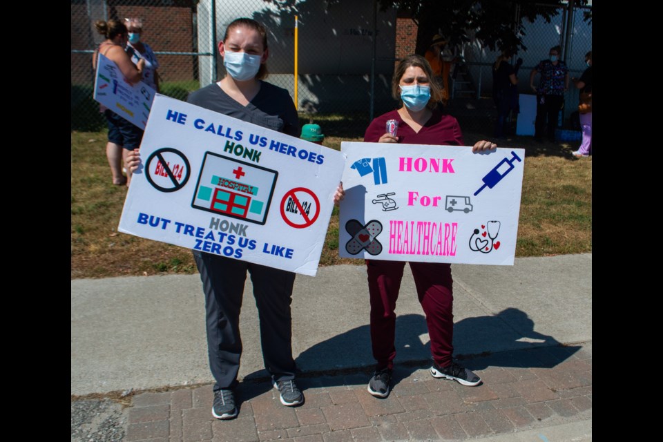 Personal support workers Elissa Bennett and Kait Rak were among those protesting Bill 124 outside Orillia Soldiers' Memorial Hospital on Tuesday afternoon.