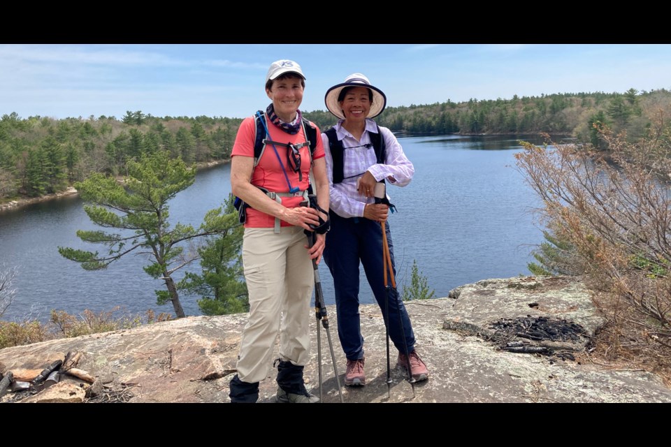 Members of the Orillia and Barrie chapters of the Ganaraska Hiking Club revelled in the Canadian Shield, witnessed industrious beavers and even stumbled across a snake during a hike at McCrae Lake north of Orillia. Above, Teri Tworzyanski, left, and Cita Wong take a break to enjoy the scenery.