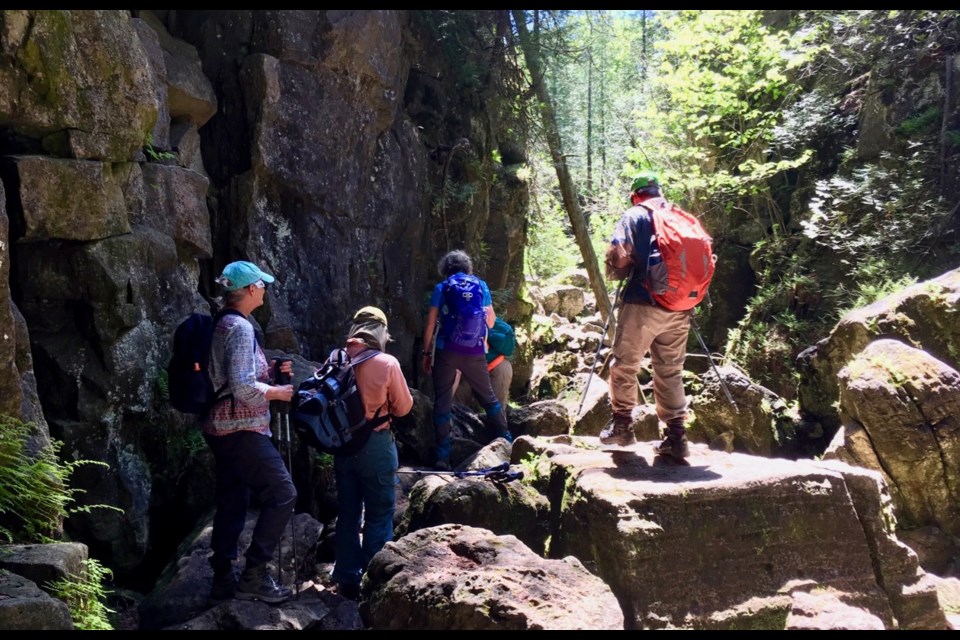 Members of the Ganaraska Hiking Club explore a crevice in the limestone 'caves' during a recent trek to Kolapore. Contributed photo