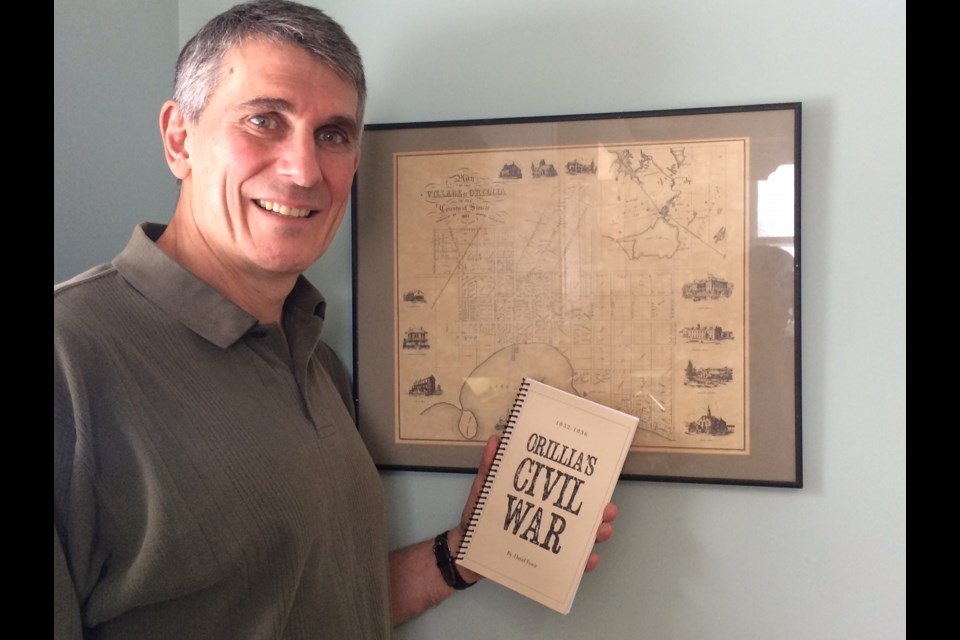 Dave Town is shown with one of the many books he's written, Orillia's Civil War.