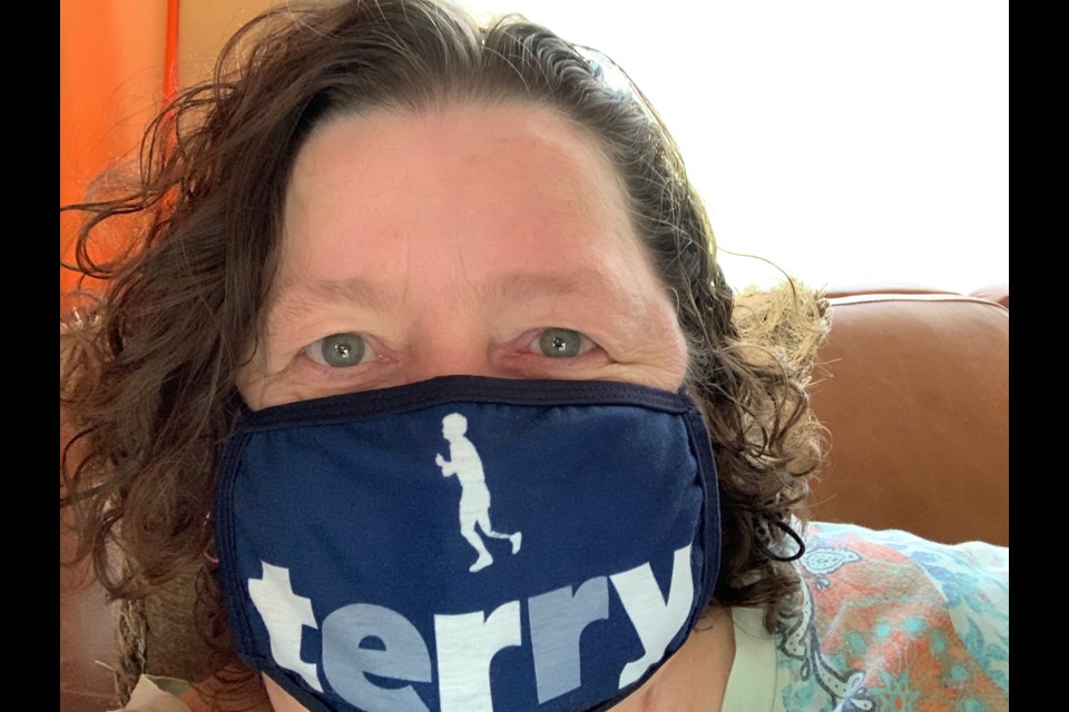 Alison Stoneman, shown donning a mask featuring her hero, Terry Fox, is celebrating 25 years of being cancer free.
